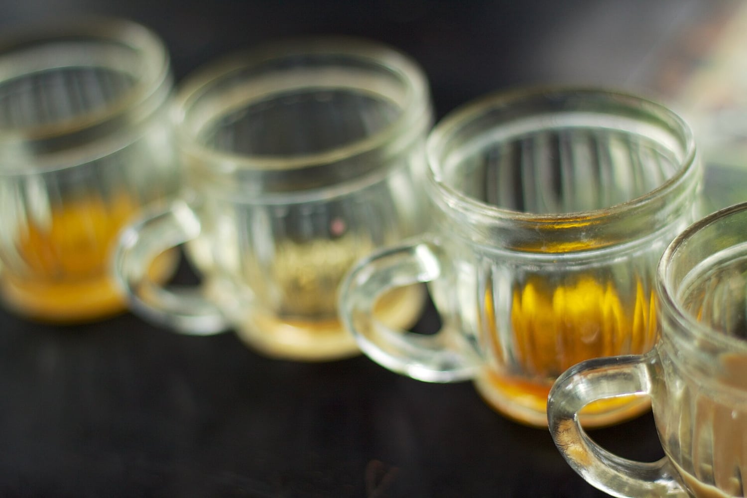 Small glasses of plantation-made coffees and teas arranged for tasting in Ubud, Bali