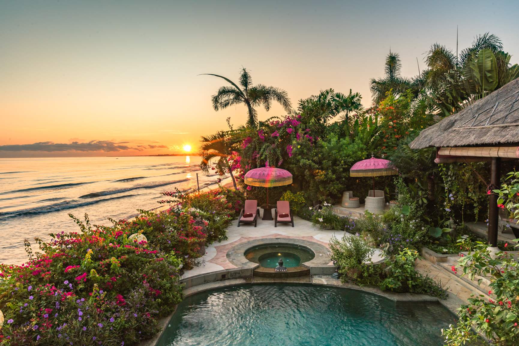 Low sun over the Bali Sea from the beachfront garden at Villa Kupu Kupu Tulip, its pool and jacuzzi among bougainvillea on the north coast