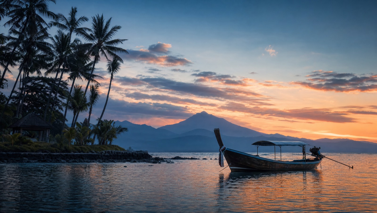 Serene tropical Bali coastline at sunset with a longtail boat