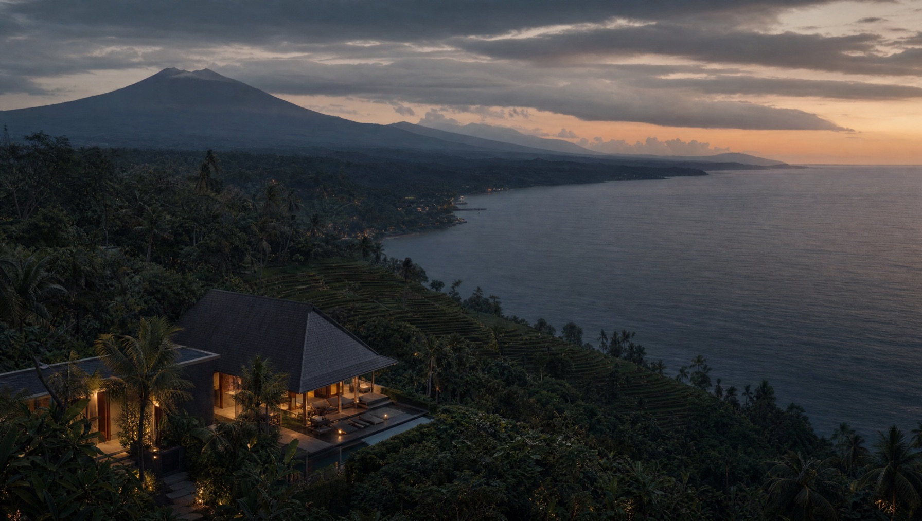 Hillside villa overlooking the north Bali coast at dusk, land and sea