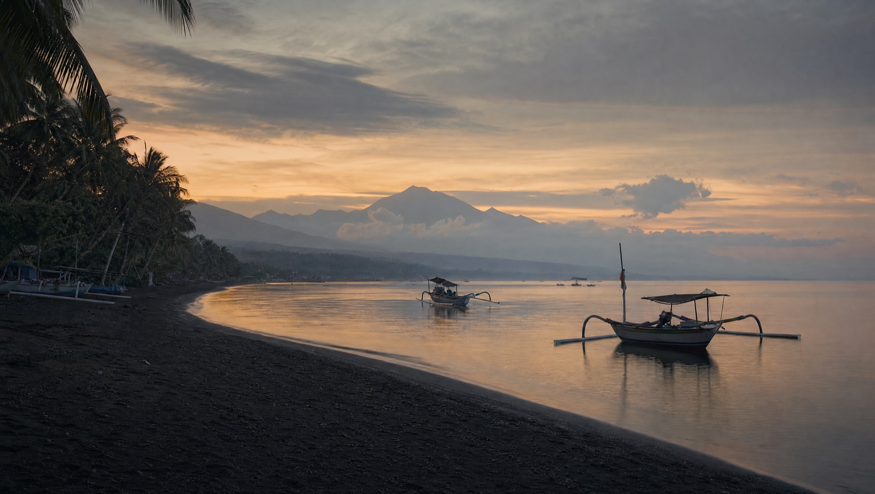 Calm black-sand beach and traditional jukung boats at Lovina, north Bali