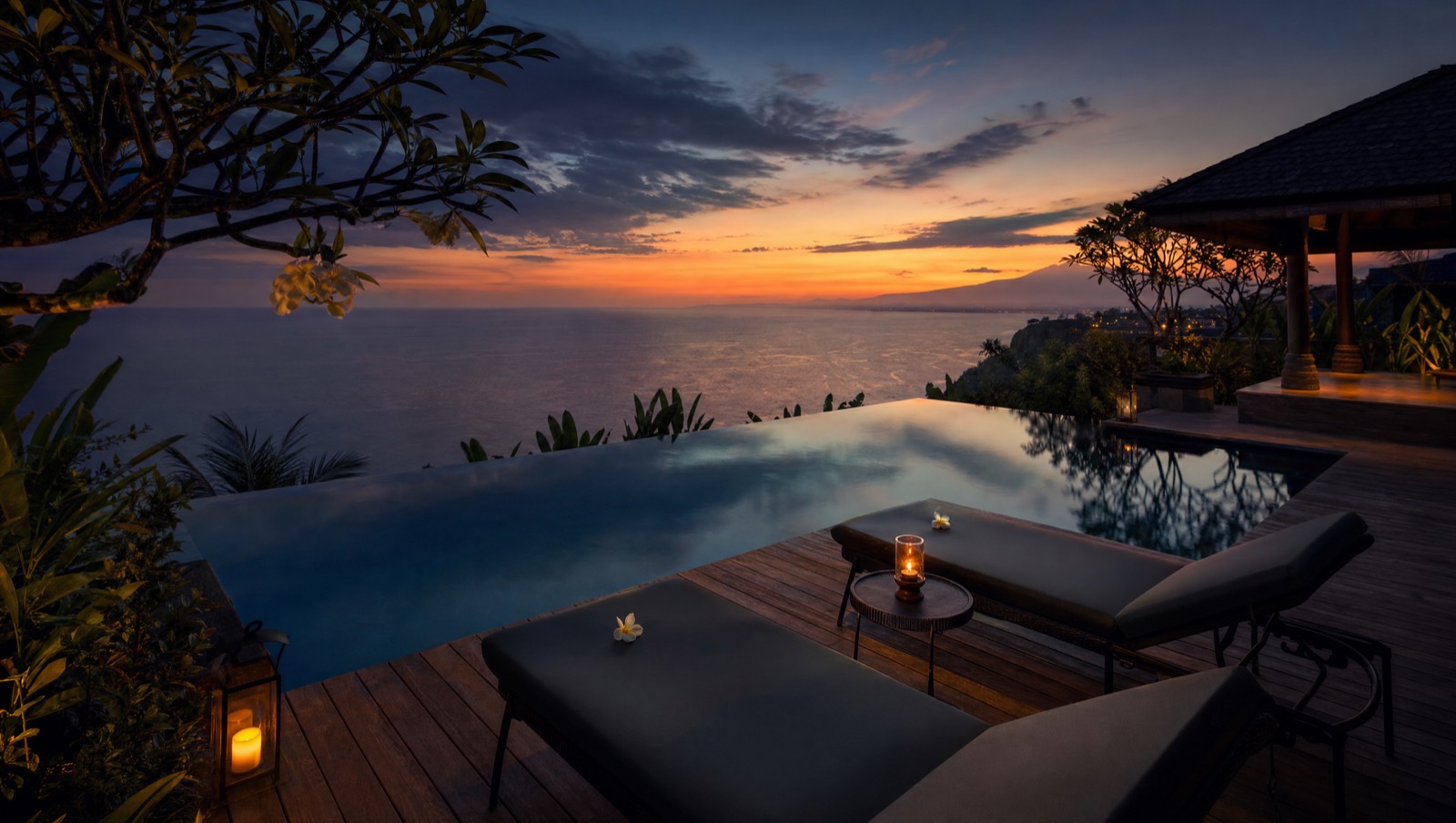 Private villa pool deck at sunset over the calm north Bali sea