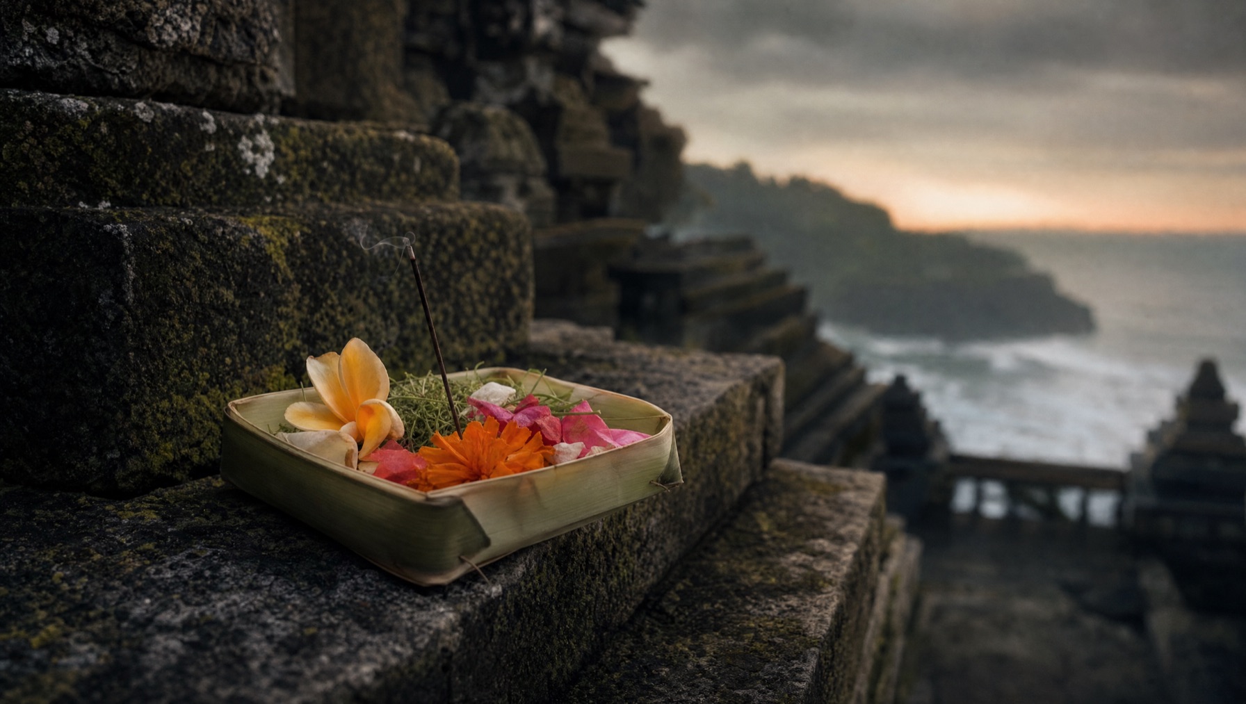 Canang sari offering with coloured flowers and incense on a Balinese shrine